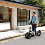 handsome-young-guy-in-casual-clothes-riding-electric-schooter-outdoors-at-sunny-daytime